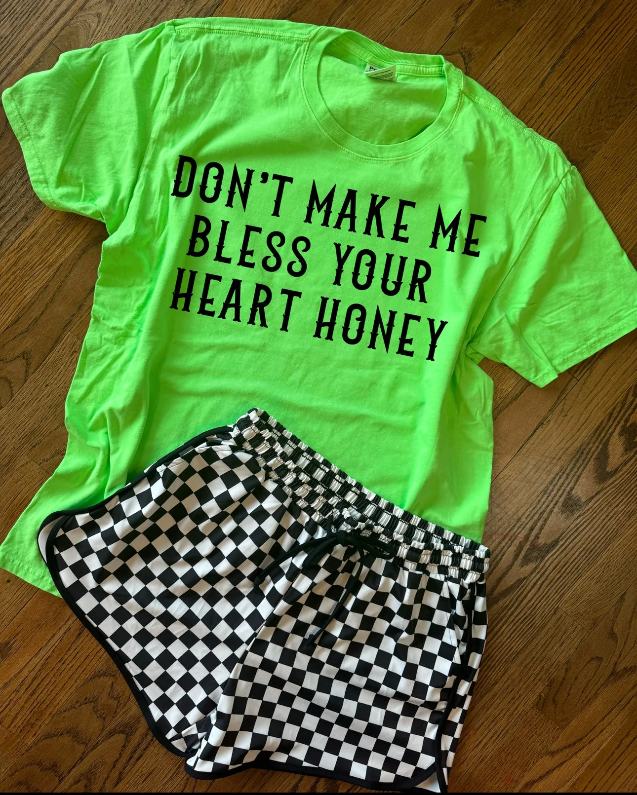 The neon Don’t Make Me Bless Your Heart Honey Collection on Comfort Colors or Beach Wash Graphic Tees // checkered shorts and joggers sold separately