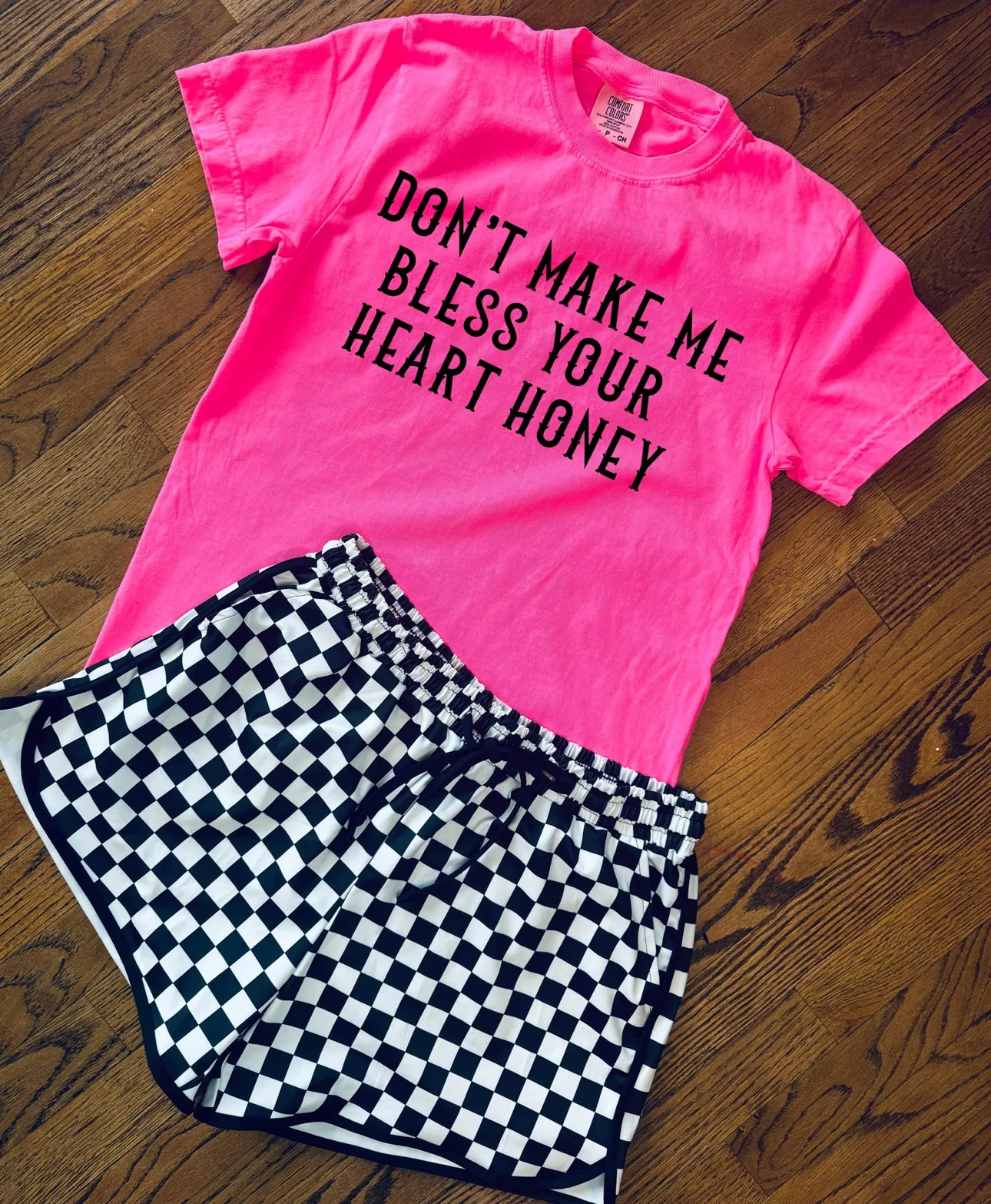 The neon Don’t Make Me Bless Your Heart Honey Collection on Comfort Colors or Beach Wash Graphic Tees // checkered shorts and joggers sold separately